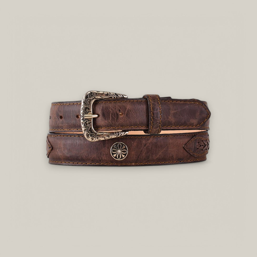 The Siberia Moka Belt is a brown leather accessory featuring a decorative roller buckle and embossed floral detailing, epitomizing classic elegance. Coiled neatly against a neutral backdrop, its the perfect blend of style and sophistication for women.