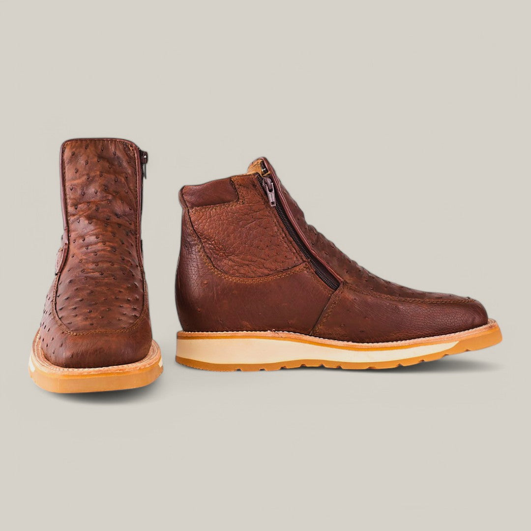 Two Exotic Ostrich - Mink - Ankle Boots in brown with ostrich leather texture and vibrant yellow soles. One boot elegantly showcases the sleek zipper side view, while the other highlights its classic rounded toe shape, exemplifying luxury footwear craftsmanship.
