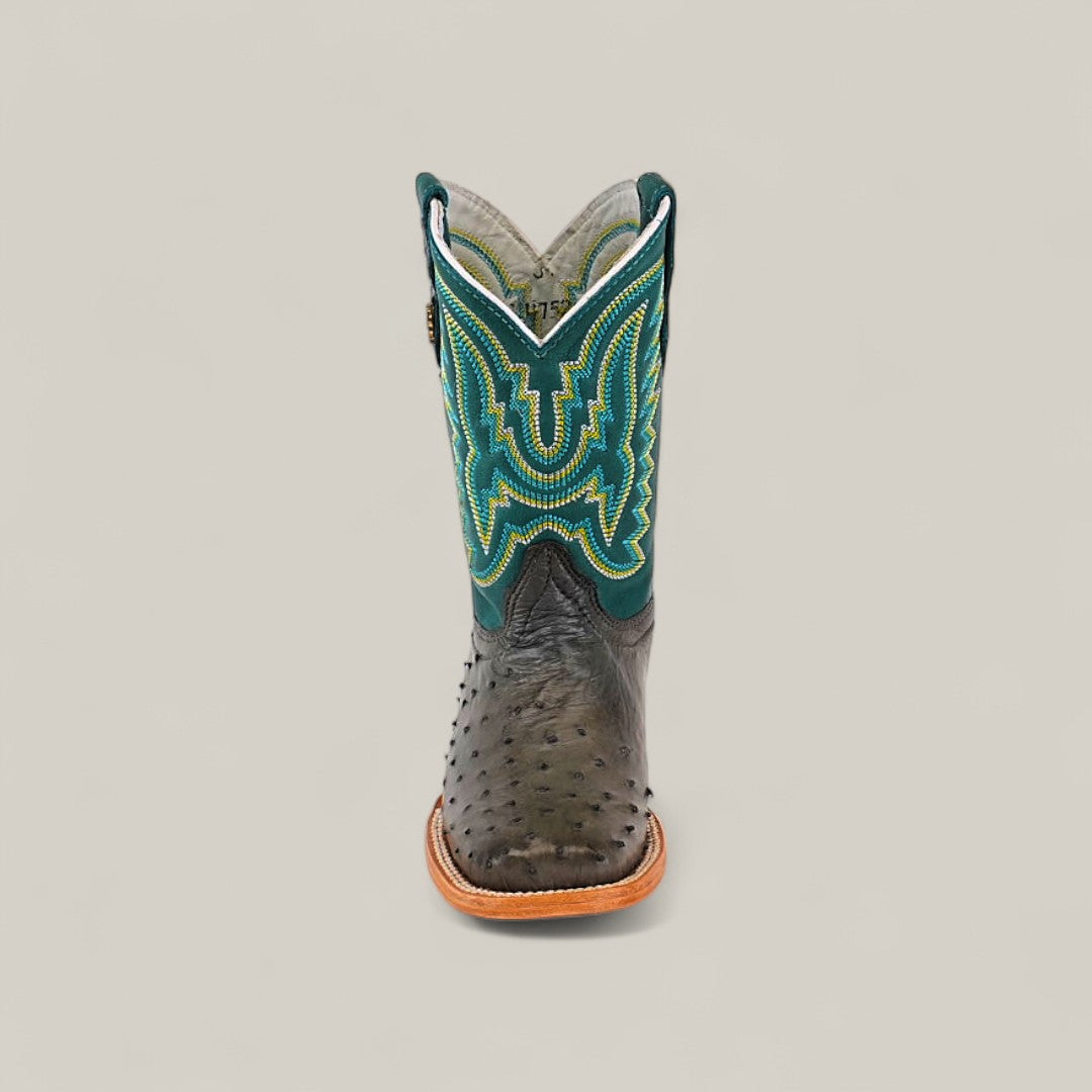 Front view of the Exotic Full Quilt Ostrich Gray - Square Toe Kids Boot, featuring textured gray ostrich leather, a tan sole, and a decorative green, yellow, and blue stitched upper—highlighting western style against a light background.
