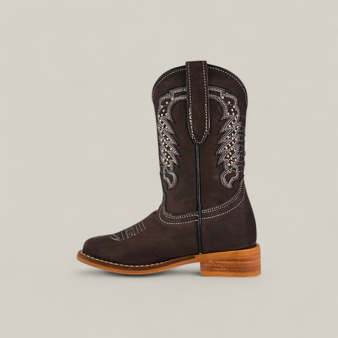 A single Orion Suede Oxford - Square Toe Kids Boot in dark brown with white decorative stitching and a light brown wooden heel, displayed in profile on a plain light background.