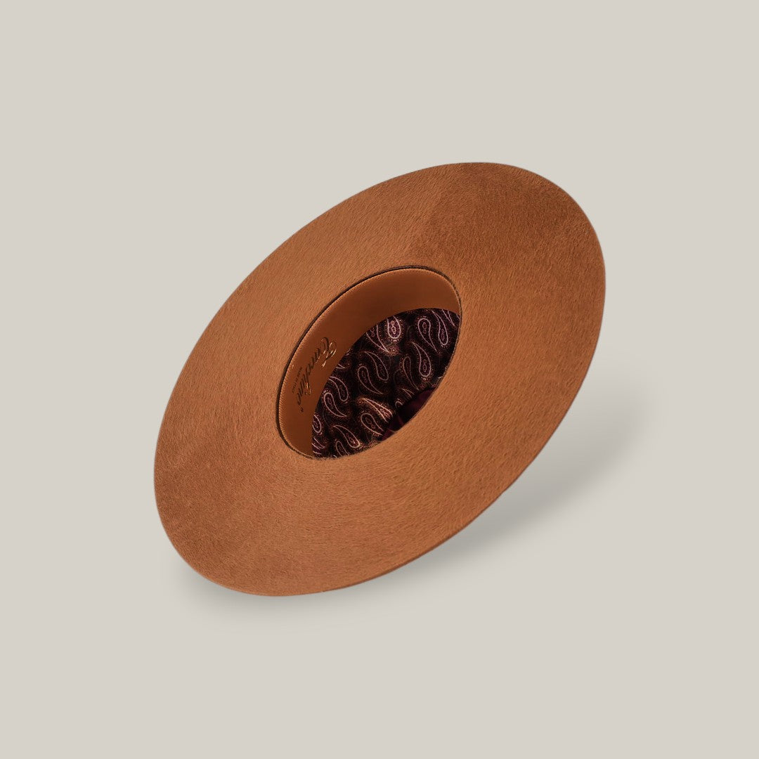 The 10X Grizzly - Tacchino is a brown, wide-brimmed open crown felt hat featuring a round cutout center that reveals a decorative patterned lining—an elegant luxury accessory, displayed on a neutral background.