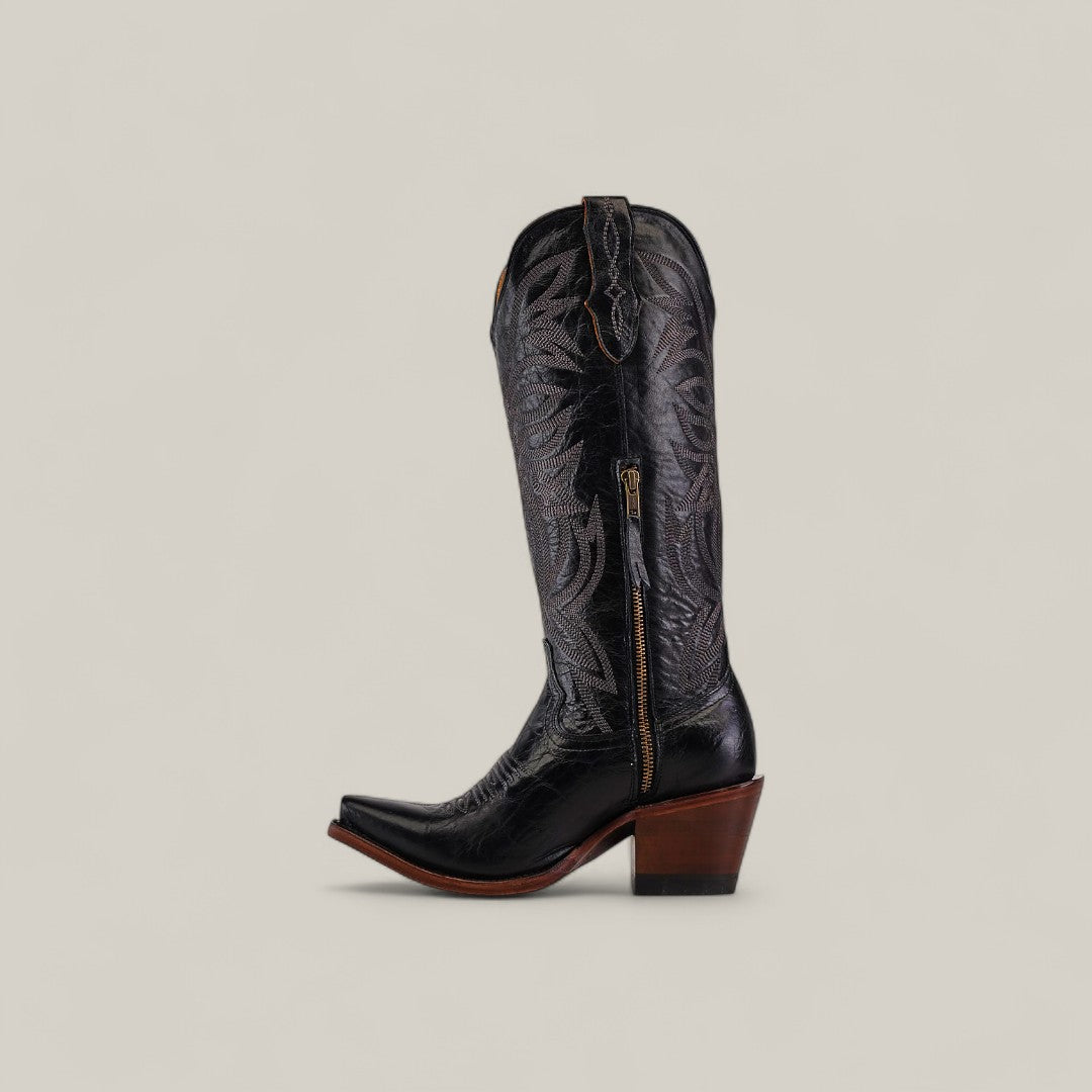 The Kellie Clayton Black Leather Sole Boot features a tall shaft, snip toe, decorative stitching, side zipper, and sturdy angled brown heel. These striking boots are displayed on a plain light background.