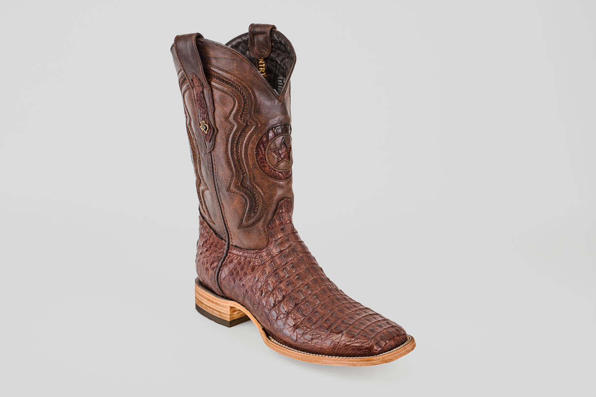 The Exotic Caiman Horn Back - Brown - Square Toe boot features textured caiman leather, decorative stitching, a wooden sole, and is showcased against a plain light gray background.