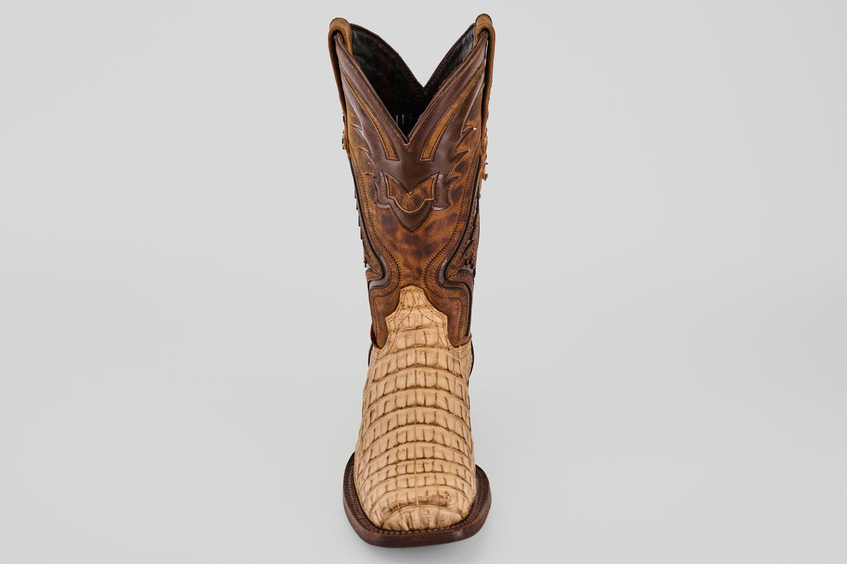 The Exotic Caiman Hornback - Orix - Rodeo Toe boot features a light tan, textured lower and a darker brown, intricately stitched upper, displayed front-facing against a plain white background.