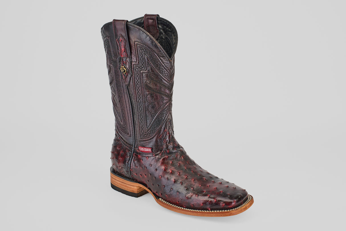 A single handcrafted Exotic Full Quilt Ostrich cowboy boot in black cherry with a square toe and decorative details, displayed against a plain background—ideal for those who love unique, luxurious boots.