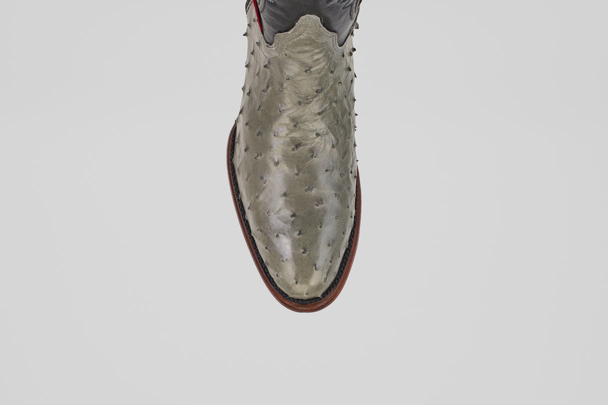 A top view of the Austin - Oxford - Round Toe men's cowboy boot, crafted from ostrich leather with a textured, bumpy surface and a brown sole, set against a plain white background.