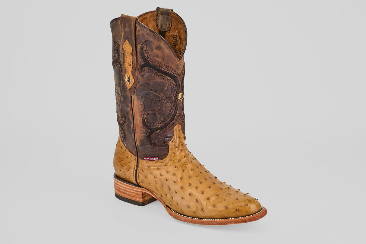 The Austin - Antique - Roper Toe boot features a light tan ostrich leather foot, dark brown stitched shaft, stacked wooden heel, and roper toe—a refined example of quality ostrich boots on a light gray background.