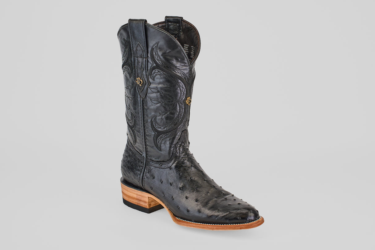The Austin - Black - Roper Toe is a single black western boot crafted from ostrich leather, featuring decorative stitching, a wooden heel, and a pointed toe, displayed against a plain light background.