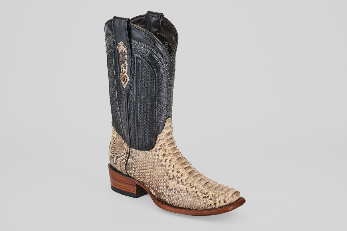 The Tanner - Natural - Narrow Square Toe is a Western-style cowboy boot featuring a light tan, textured exotic snakeskin lower, a dark smooth leather upper with decorative stitching, and a brown wooden heel, shown on a plain light background.