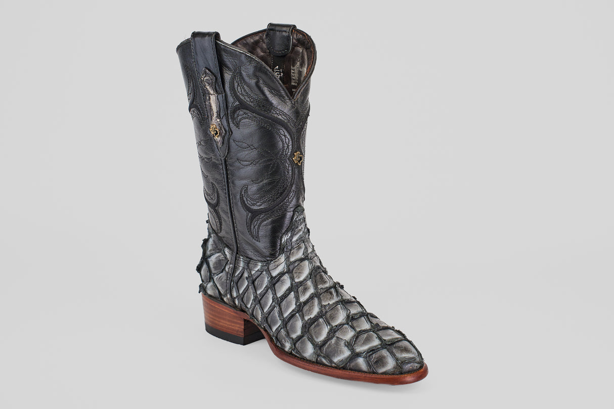 The Conor - Newspaper - Roper Toe is a unique boot with a black stitched upper, scaly pirarucu-style lower, and brown stacked heel—ideal for those seeking standout exotic roper toe boots.