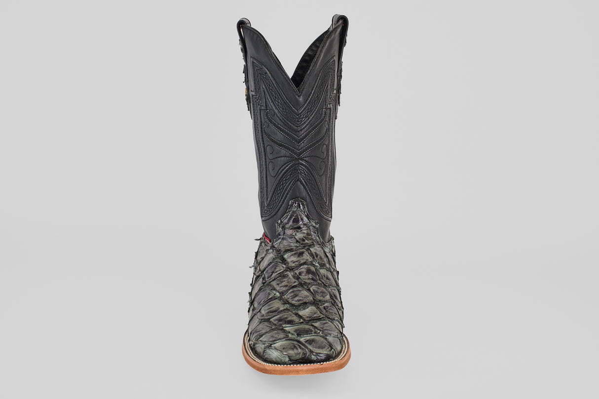 The Conor - Charcoal - Square Toe men's cowboy boot features a black textured upper and a scaly dark green fish leather lower, showcased from the front against a plain white background.