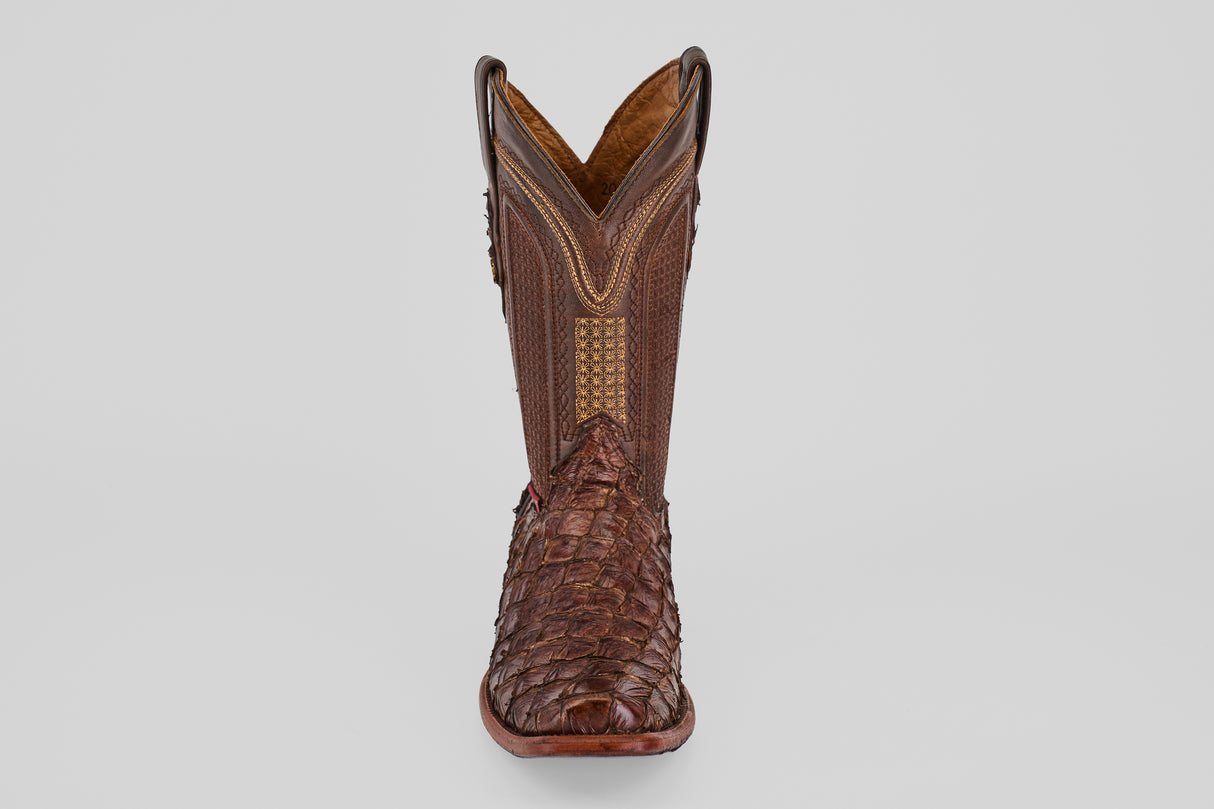The Conor - Brown - Narrow Square Toe boot features textured fish leather on the foot and decorative stitching on the shaft, displayed upright facing forward against a plain gray background.