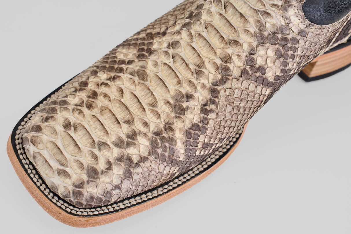 Close-up of the Tanner - Matte Natural - Square Toe cowboy boots, featuring textured snakeskin with a natural pattern, detailed stitching, and a light-colored wooden sole.