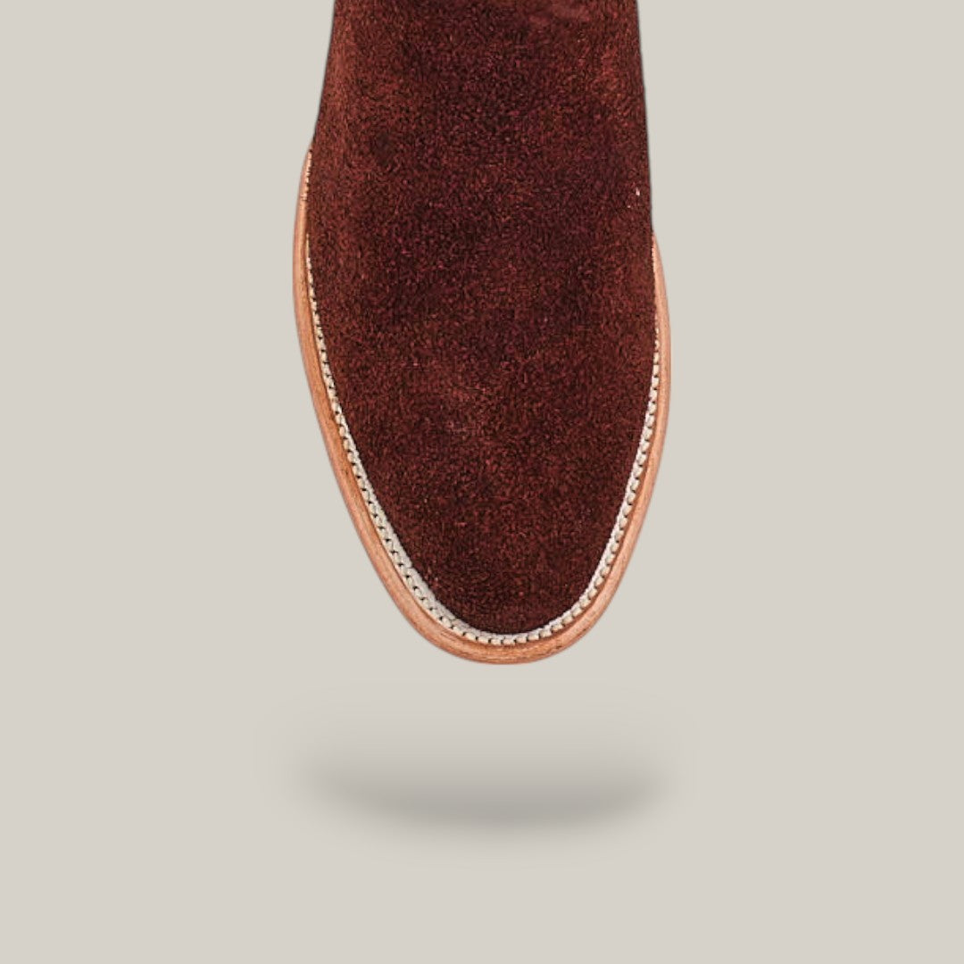Top view of the Dusty - Classic Brown - Roper Toe boot with a rounded toe and tan leather welt, photographed against a light beige background.