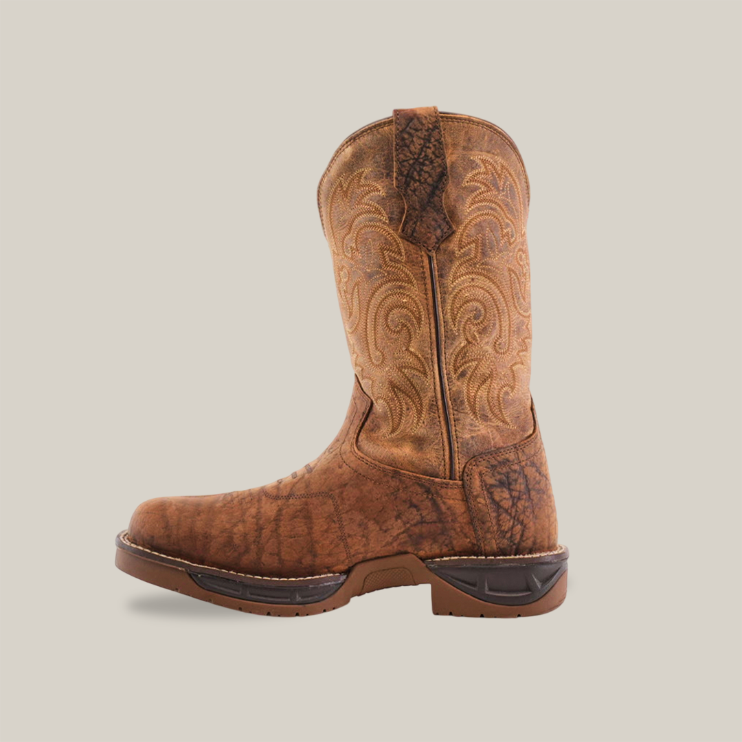 The Tan Brown Rough Out - Waterproof - Soft Toe displays a brown cowboy boot made from premium cowhide leather with intricate embroidery on the shaft against a plain white background. A slightly worn look and features like a sturdy sole and pull tab highlight its handcrafted excellence.
