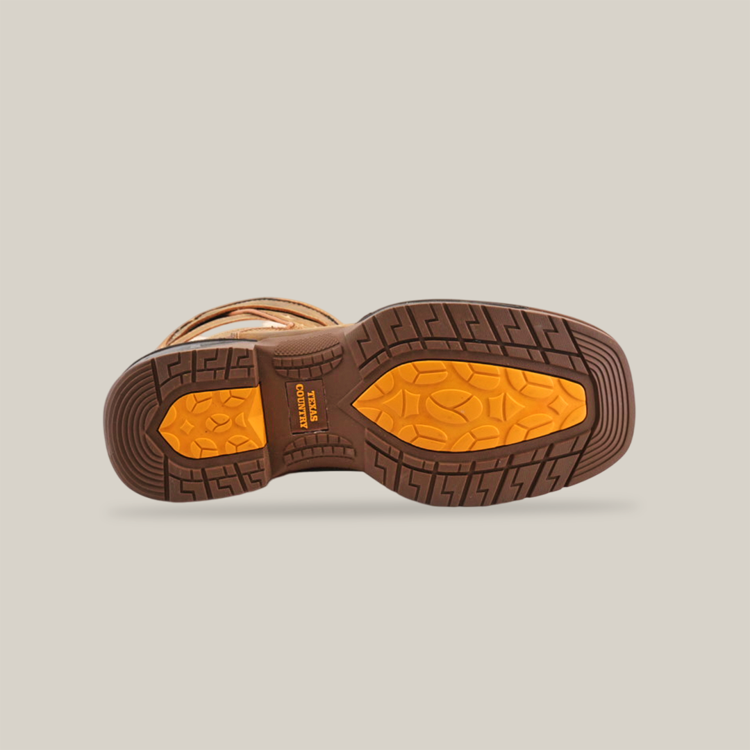 View of a boot sole with intricate tread design featuring a bright orange Oil Resistant section. Crafted from premium cowhide leather, the White Tan US Flag - Waterproof - Soft Toe boot is set against a white background, highlighting its texture and pattern.