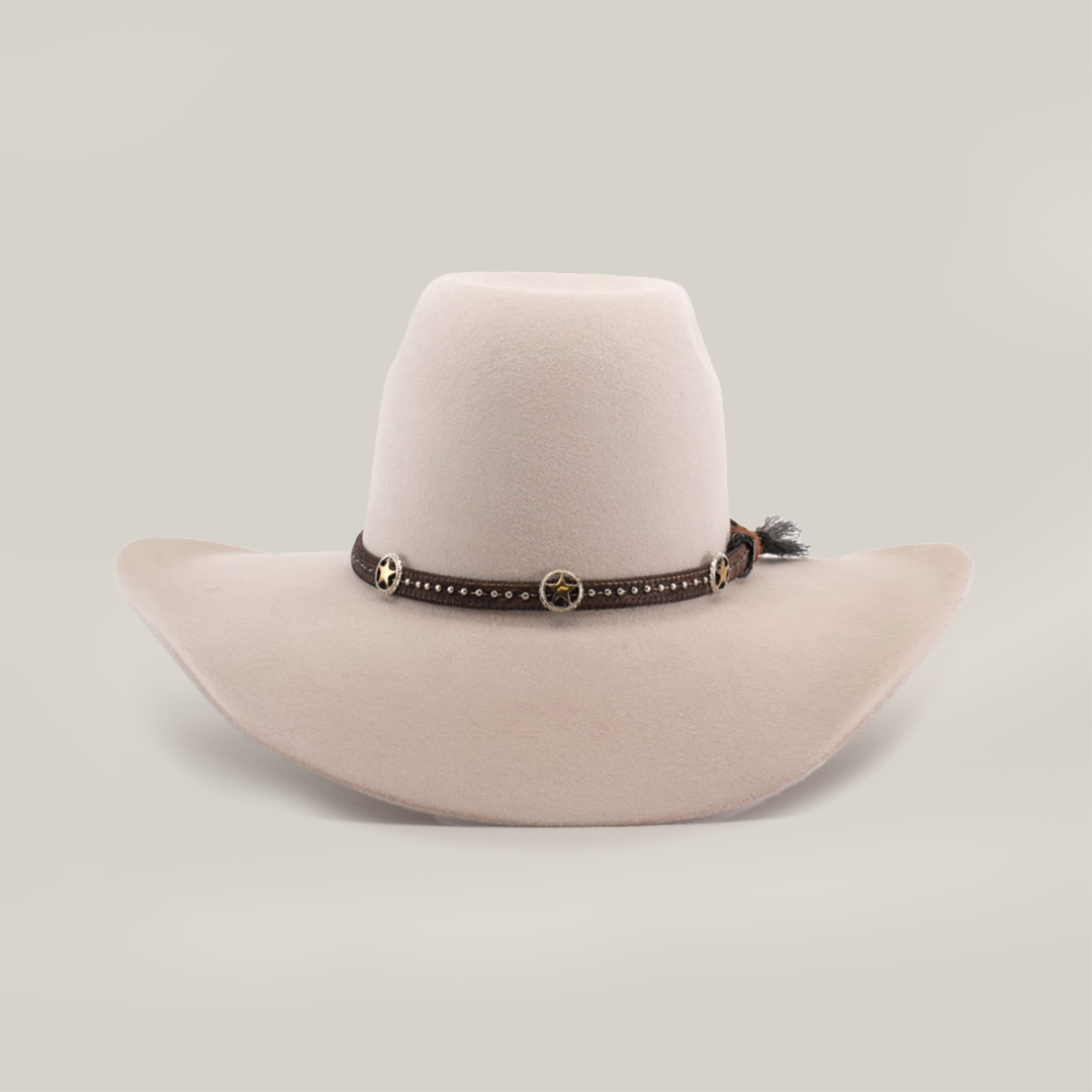 The 6X Brazil Belly is a wide-brimmed beige cowboy hat made from genuine sheep wool, featuring a premium leather band with small golden star-shaped decorations and studs. It has a high crown and a slightly curved brim.