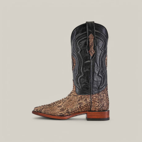 The side view of the Exotic Python - Rustic Bone - Square Toe boots highlights their Western appeal, featuring a black upper and brown python leather lower with decorative stitching on the shaft and a wooden heel, all set against a plain gray background.