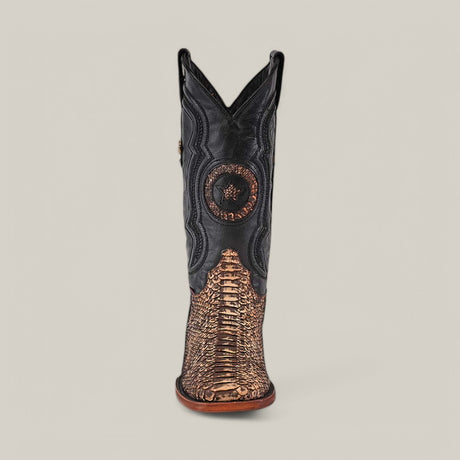 The Exotic Python - Rustic Bone boot, with its detailed black leather and reddish-brown vamp, captures Western charm. Its square toe and shafts decorative design evoke rustic elegance against a gray backdrop.