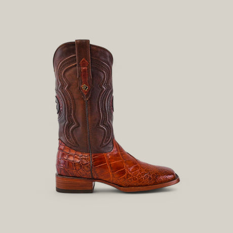 The Exotic American Alligator Hornback in Cognac is perfect for those seeking style with an edge, featuring a rich brown leather upper, a reddish-brown crocodile-patterned lower part, a square toe design, decorative stitching on the shaft, and a low wooden heel.