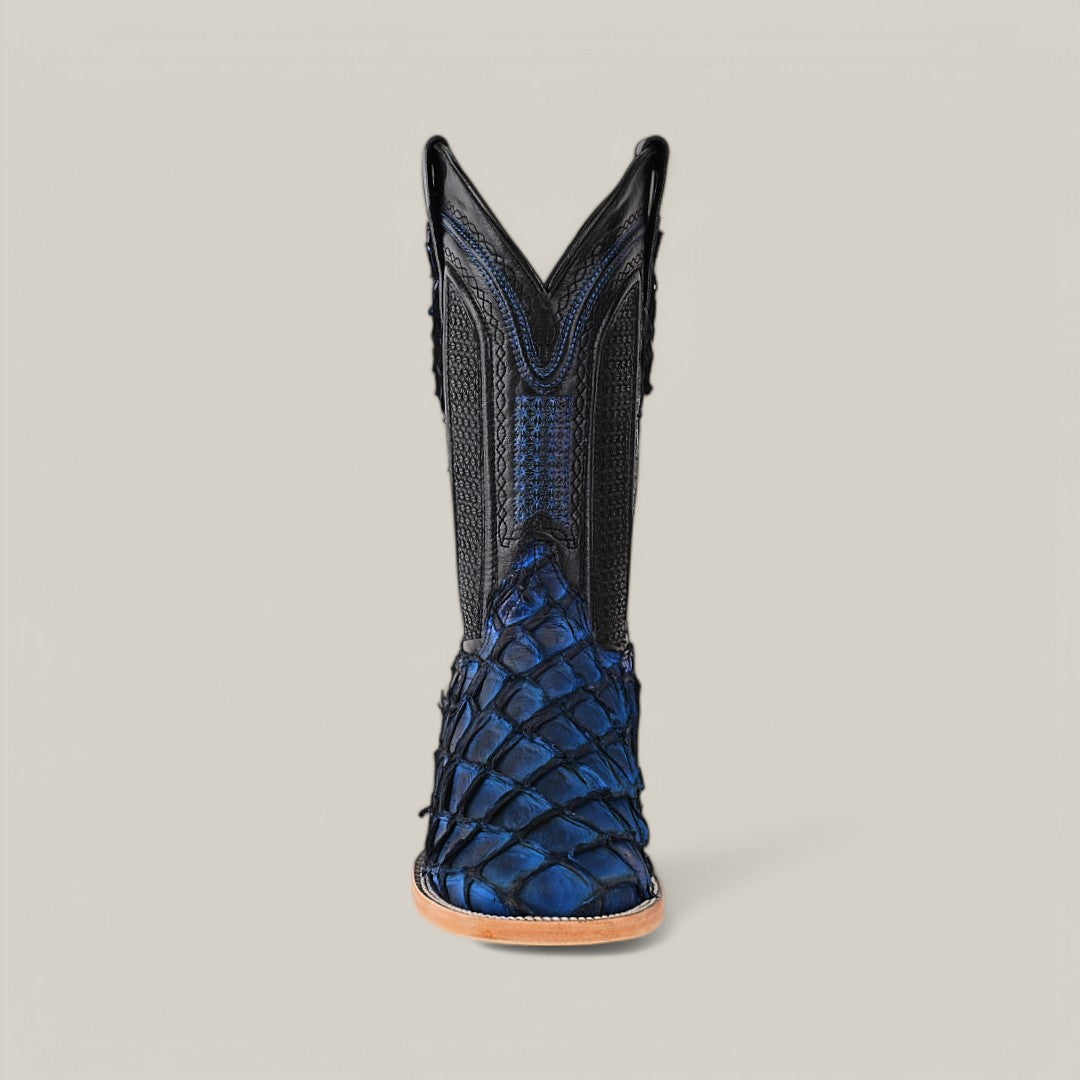 Front view of the Exotic Pirarucu Fish - Dark Blue Square Toe boot, featuring a textured lower half reminiscent of fish scales and a black upper with decorative stitching, set against a neutral gray background. This boot has pointed V-shaped shafts, adding an exotic touch.
