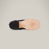 The image displays the sole of an Exotic Pirarucu Fish - Dark Blue Square Toe Boot. Made from light tan leather, it showcases the Texas Outlaw brand and logo. The black heel with small treads offers grip, blending style and exotic elegance beautifully.