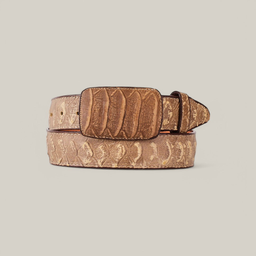 The Python Print Cappuccino Belt features a Texas buckle and showcases embossed patterns that mimic scales and ridges for a python print design. Crafted from premium brown leather, its elegantly displayed coiled with the buckle forward on a plain light background.