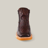 An Exotic Ostrich Ankle Boot in dark brown, with a textured ostrich leather design, light brown sole, and side zipper, displayed against a light gray backdrop.