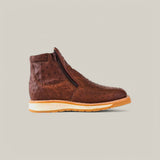 The Exotic Ostrich - Mink - Ankle Boot, made from premium ostrich leather, is displayed against a beige background. This luxury footwear boasts a dimpled texture, side zipper, and a light tan sole enhancing its rich brown color.