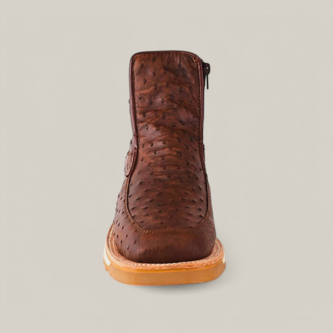 Front view of the Exotic Ostrich - Mink - Ankle Boot with a beige sole on a light gray background, crafted in rich ostrich leather with a textured bump surface and featuring a sleek side zipper.