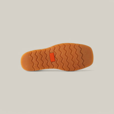 The image displays the sole of the Exotic Python - Brown - Ankle Boot featuring a light brown zigzag pattern and a small red rectangle at the center. The plain, light background enhances the exotic allure of this trendy footwear.