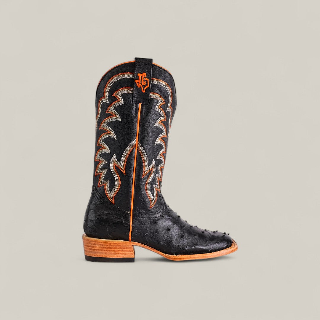 The Exotic Full Quilt Ostrich - Black - Square Toe boot features decorative stitching, orange accents, a light brown wooden heel and sole, exotic black ostrich leather, bold shaft embroidery, and a branded pull tab from the Platinum collection.