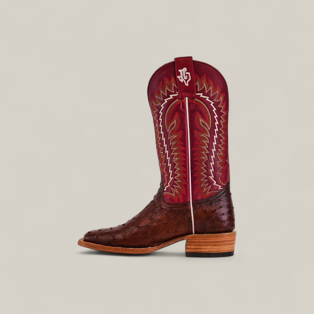 The Exotic Full Quilt Ostrich - Red/Brown - Square Toe Boot features a brown textured leather lower and a vibrant red upper with intricate yellow stitching, a white logo near the top, from the Platinum Collection, set against a plain light background.