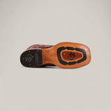 A close-up of the Exotic Full Quilt Ostrich - Red / Brown - Square Toe sole shows tan leather with black insets, a logo, signature, and textured grip areas against a plain light background.
