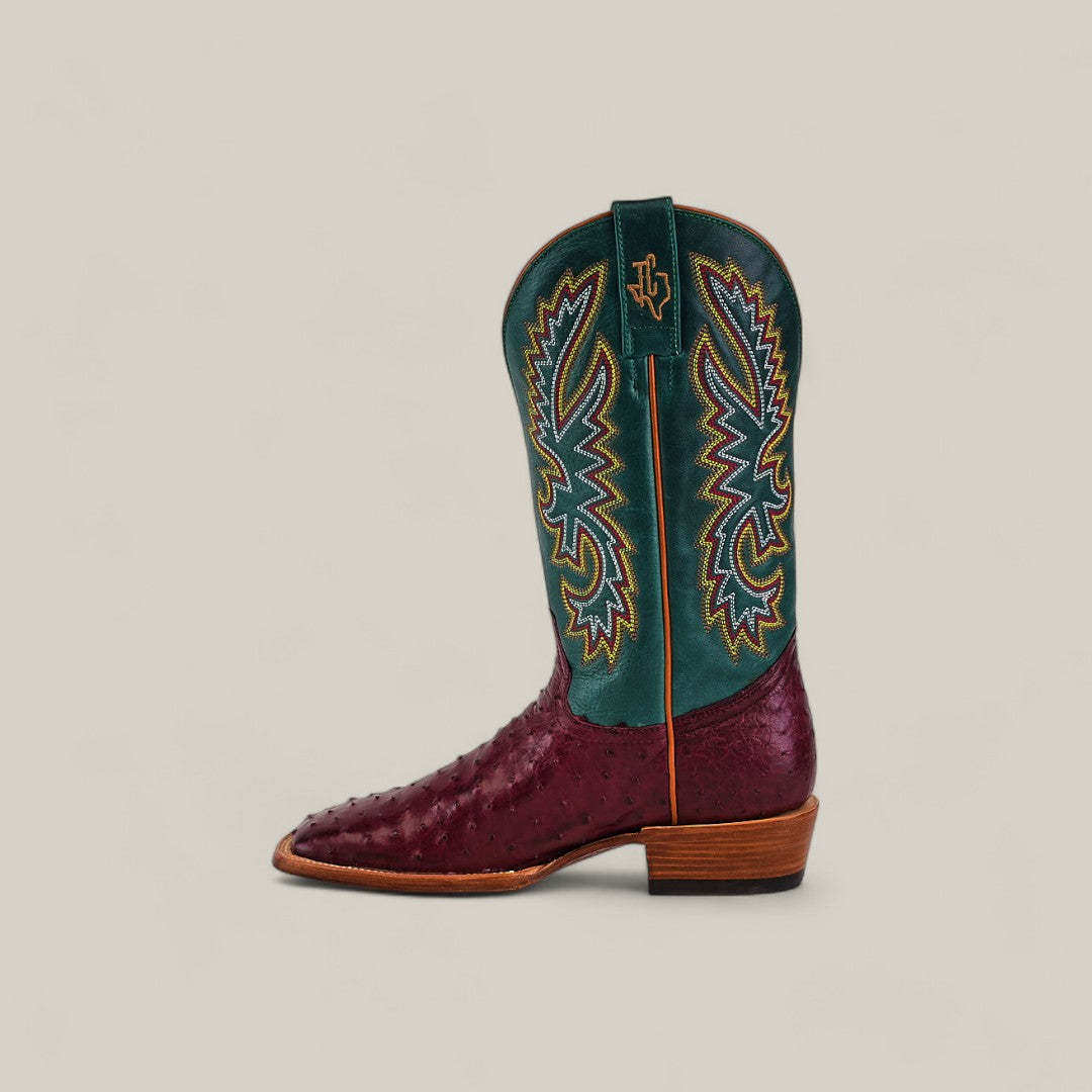 The Exotic Full Quilt Ostrich - Wine - Square Toe boot from the Platinum Collection features a burgundy leather foot, green shaft with colorful stitching, and is displayed against a plain beige background.