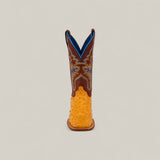 The Exotic Full Quilt Ostrich - Buttercup - Square Toe boot from the Platinum Collection features a yellow ostrich leather foot, brown upper, blue lining, and detailed blue and yellow stitching, shown upright on a plain light background.