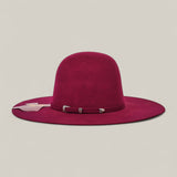 The 4X Burgundy - TC Hats is a wide-brimmed felt Western hat in burgundy with a matching decorative band and silver buckle, shown on a plain light grey background.