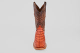 The Exotic Caiman Horn Back - Brandy - Square Toe boot, featuring a brown textured shaft and reddish patterned foot, is displayed facing forward on a plain light gray background.