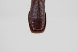 A close-up, top-down view showcases the unique texture of the Exotic Caiman Hornback - Brown - Rodeo Toe boots square toe in genuine caiman leather against a plain light gray background.