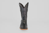 The Austin Leg - Black - Square Toe boot features decorative stitching, a star emblem on the shaft, and a light tan sole. Photographed from the front on a plain light gray background, it's ideal for square toe boot enthusiasts.