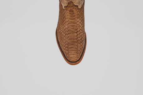 The Tanner - Tamarindo - Round Toe boot features a brown snakeskin-inspired design, showcased from above and centered on a plain white background.