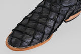 Close-up of the Conor - Matte Black - Roper Toe: a black boot with textured, square-patterned leather, light brown sole, and visible white stitching along the edge.