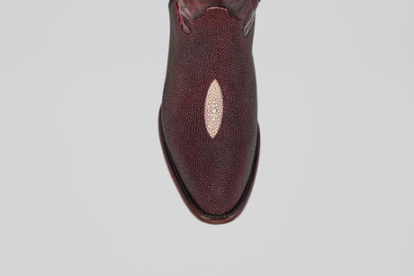 The Ranger – Wine – Round Toe, a single burgundy leather shoe featuring a unique oval light patch on the upper, reminiscent of stingray leather boots, is shown from above against a plain light gray background.