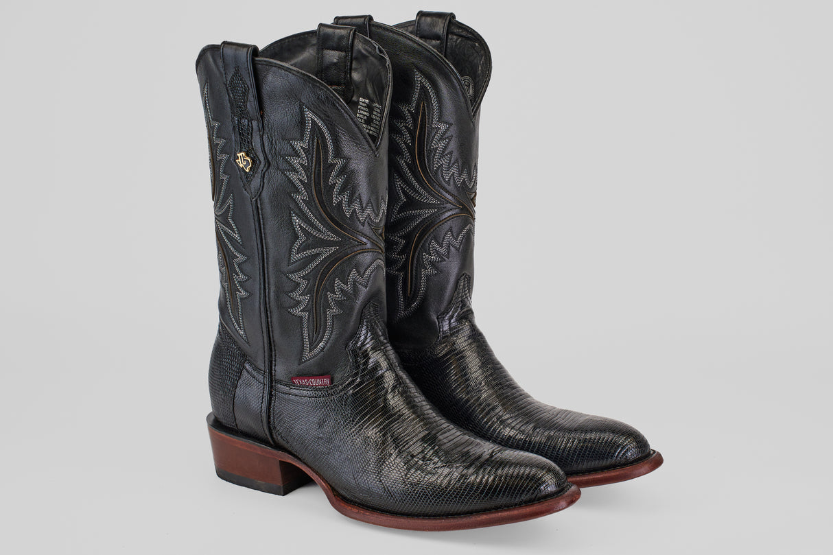 The Blaze – Black – Round Toe boots feature black lizard leather, decorative stitching, round toes, and brown soles, displayed on a plain light gray background.