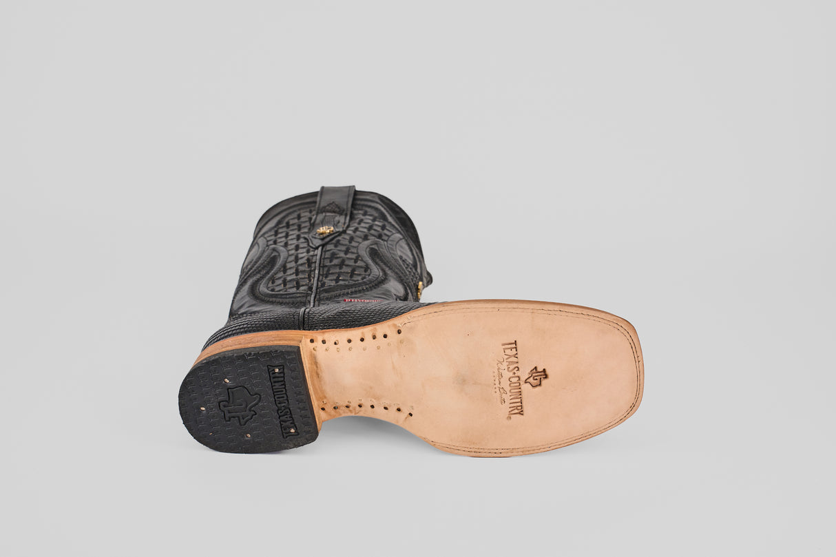 The Blaze – Black – Square Toe cowboy boot is shown on its side, highlighting its TEXAS COUNTRY-branded leather sole, stitching, and a textured genuine lizard leather upper with a classic western silhouette.