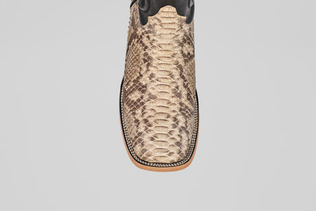 A close-up, top view of the Tanner - Matte Natural - Square Toe cowboy boot, showcasing tan and brown python leather with detailed edge stitching.
