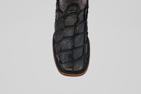 A close-up of the toe of the Conor Platinum - Matte Black - Square Toe (Diamond) boot, featuring black textured material with brown edge stitching—rugged and patterned for a distinctive western style.