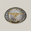 The Oval Gold Longhorn Buckle features an ornate design with a golden longhorn skull embossed at the center, surrounded by intricate alpaca silver filigree patterns on a contrasting dark background.