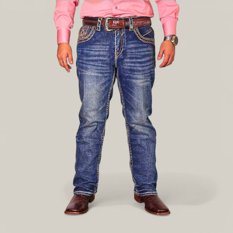 A person dons Western Blue Straight Fit Embroidered Jeans WJ-2351, a pink long-sleeve shirt, a brown belt, and brown leather shoes. Their hands feature a watch and a ring against a plain gray background.