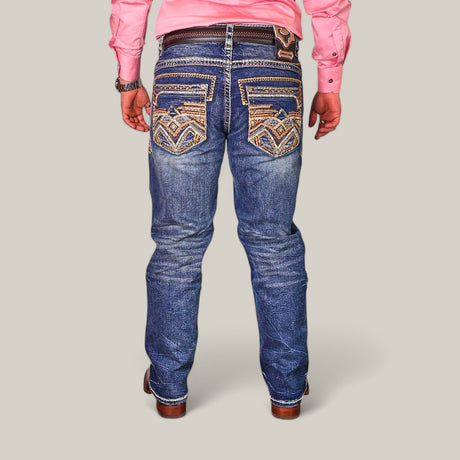 A person in a pink long-sleeve shirt, Western Blue Straight Fit Embroidered Jeans WJ-2351 with detailed back pockets, a black belt with a western-style buckle, and brown leather shoes is standing with their back to the camera.